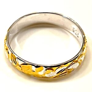 a silver and gold ring with a subtle design